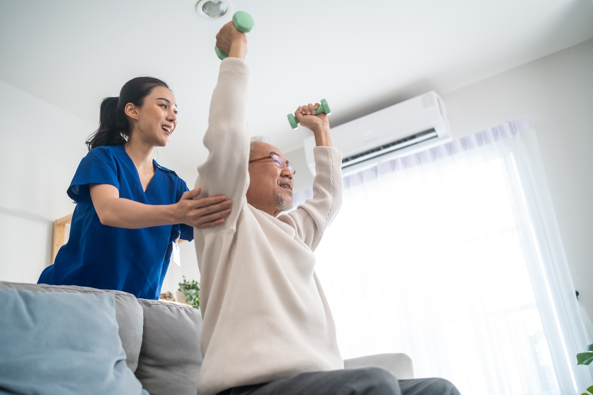 Asian senior elderly man patient doing physical therapy with caregiver. Asian senior elderly man patient doing physical therapy with caregiver.